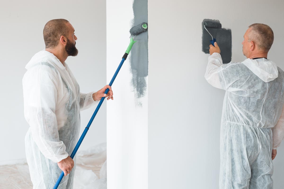 Painters painting wall